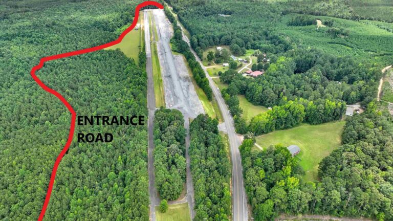 Aerial view of a drag strip and surrounding land slated for redevelopment
