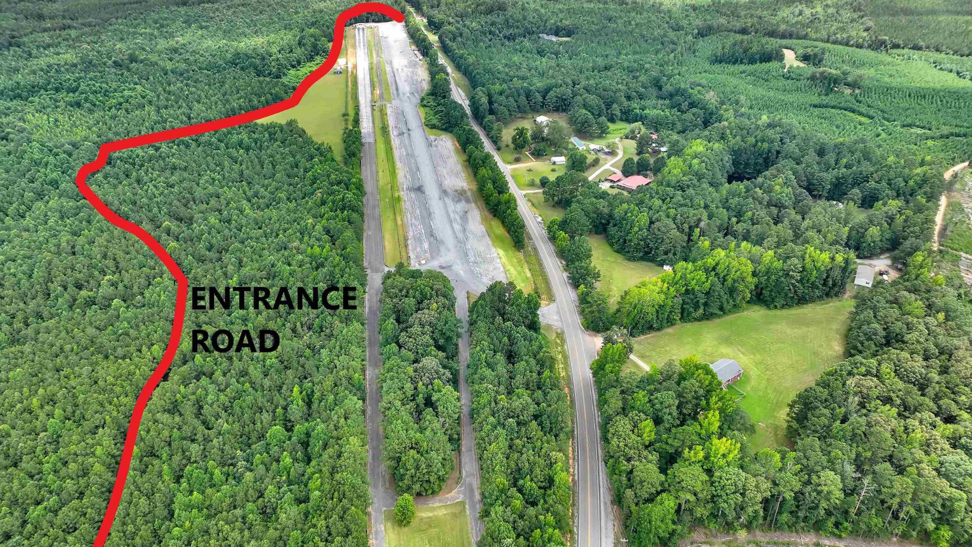 Aerial view of a drag strip and surrounding land slated for redevelopment