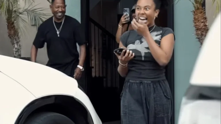 Martin Lawrence posing next to a Porsche Macan he gifted his daughter
