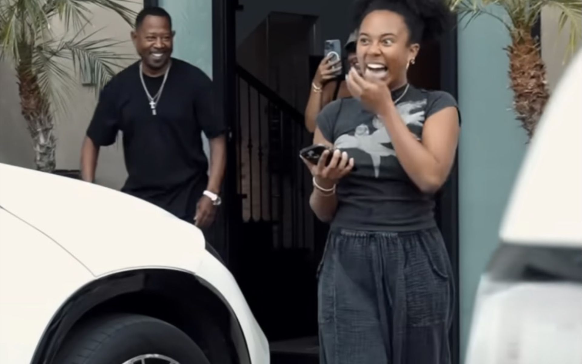 Martin Lawrence posing next to a Porsche Macan he gifted his daughter