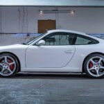 White Porsche 911 parked in a garage, similar to the 2018 model at the center of Trent Williams' lease lawsuit