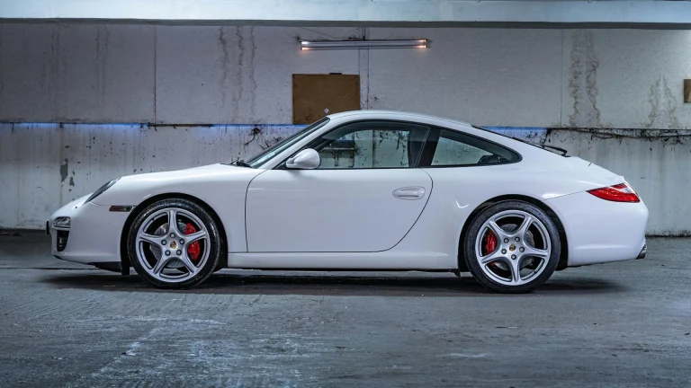White Porsche 911 parked in a garage, similar to the 2018 model at the center of Trent Williams' lease lawsuit