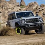 Ford Bronco off-roading on rocky terrain, representing the Bronco SUV platform a rumored pickup variant would share