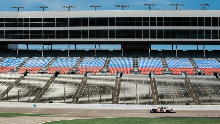 aerial photography of car on stadium under clear blue sky