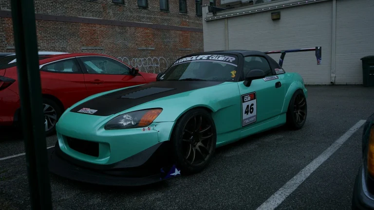a blue sports car parked in a parking lot