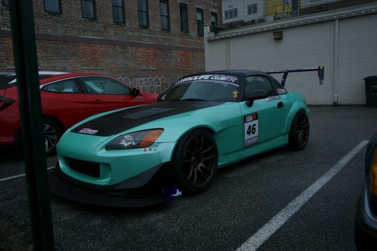 a blue sports car parked in a parking lot