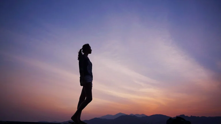 woman standing under blue sky