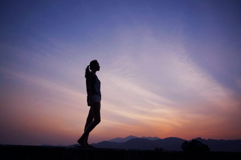 woman standing under blue sky
