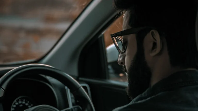 man in black jacket driving car during daytime