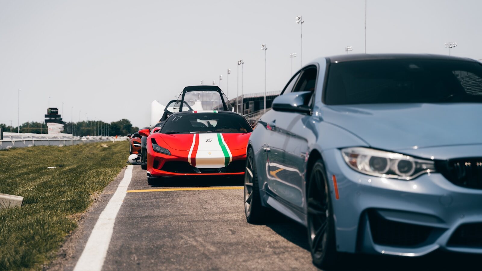a couple of cars driving down a road next to each other