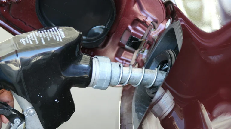 a close up of a person holding a gas pump