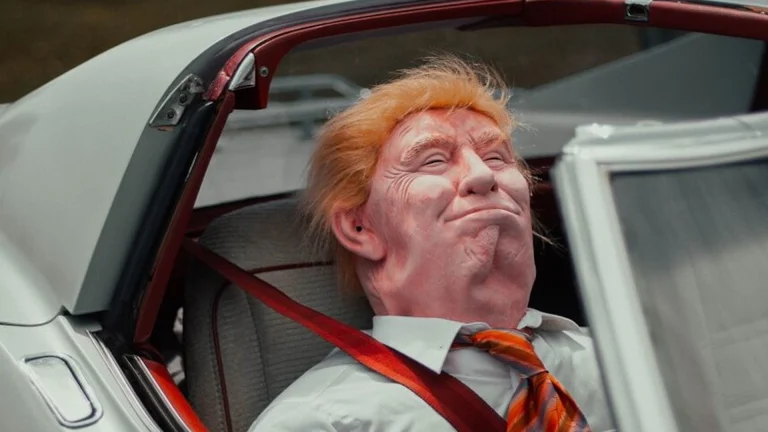 man in red white and black striped necktie sitting on car seat