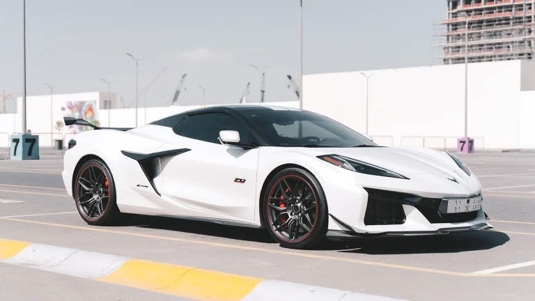 A sleek white sports car parked outdoors.