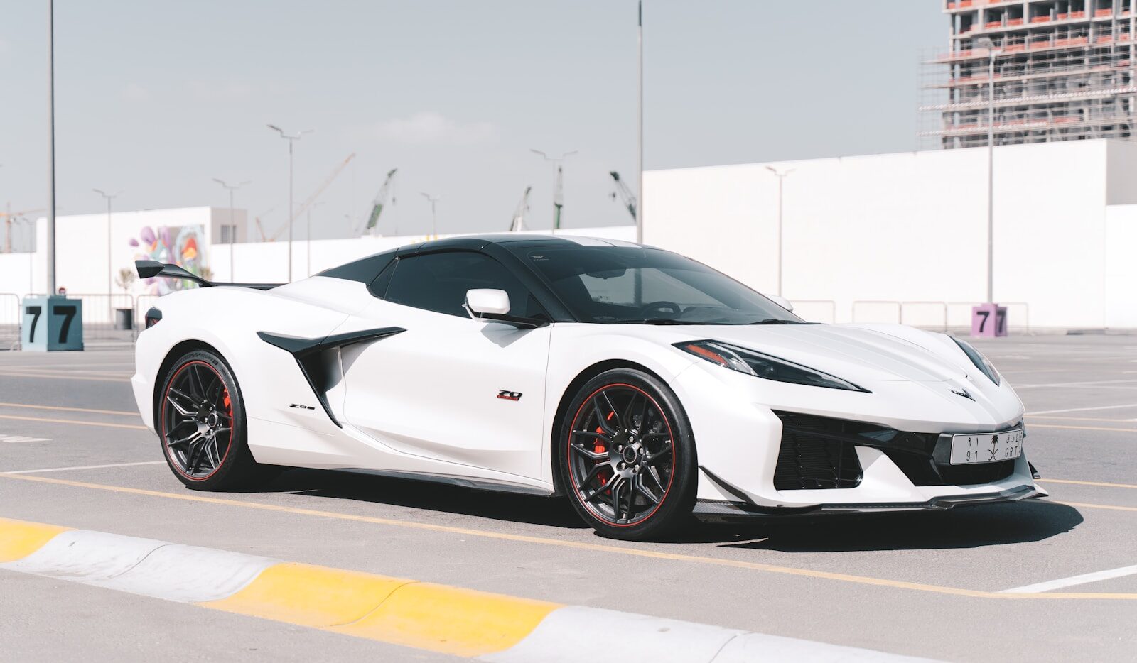 A sleek white sports car parked outdoors.