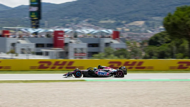 Formula 1 race car speeds down the track.