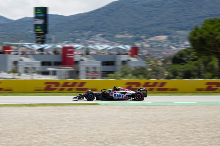 Formula 1 race car speeds down the track.