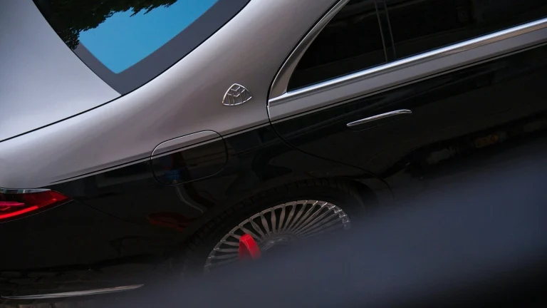 Luxury car with distinctive emblem and wheel detail.