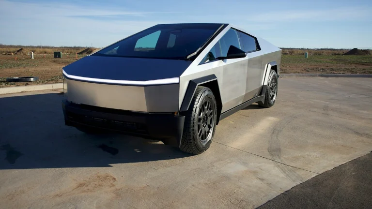 a silver and black car parked in a parking lot