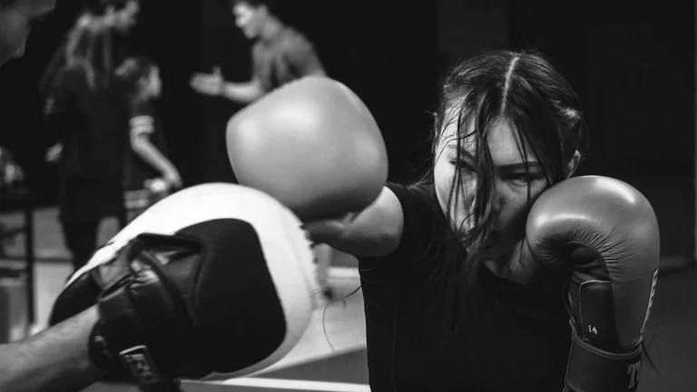 A man with long hair wearing boxing gloves