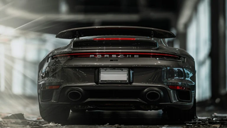 the rear end of a grey porsche sports car