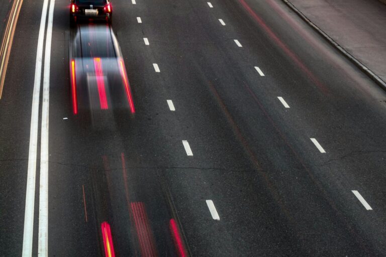 a car driving down a highway at night