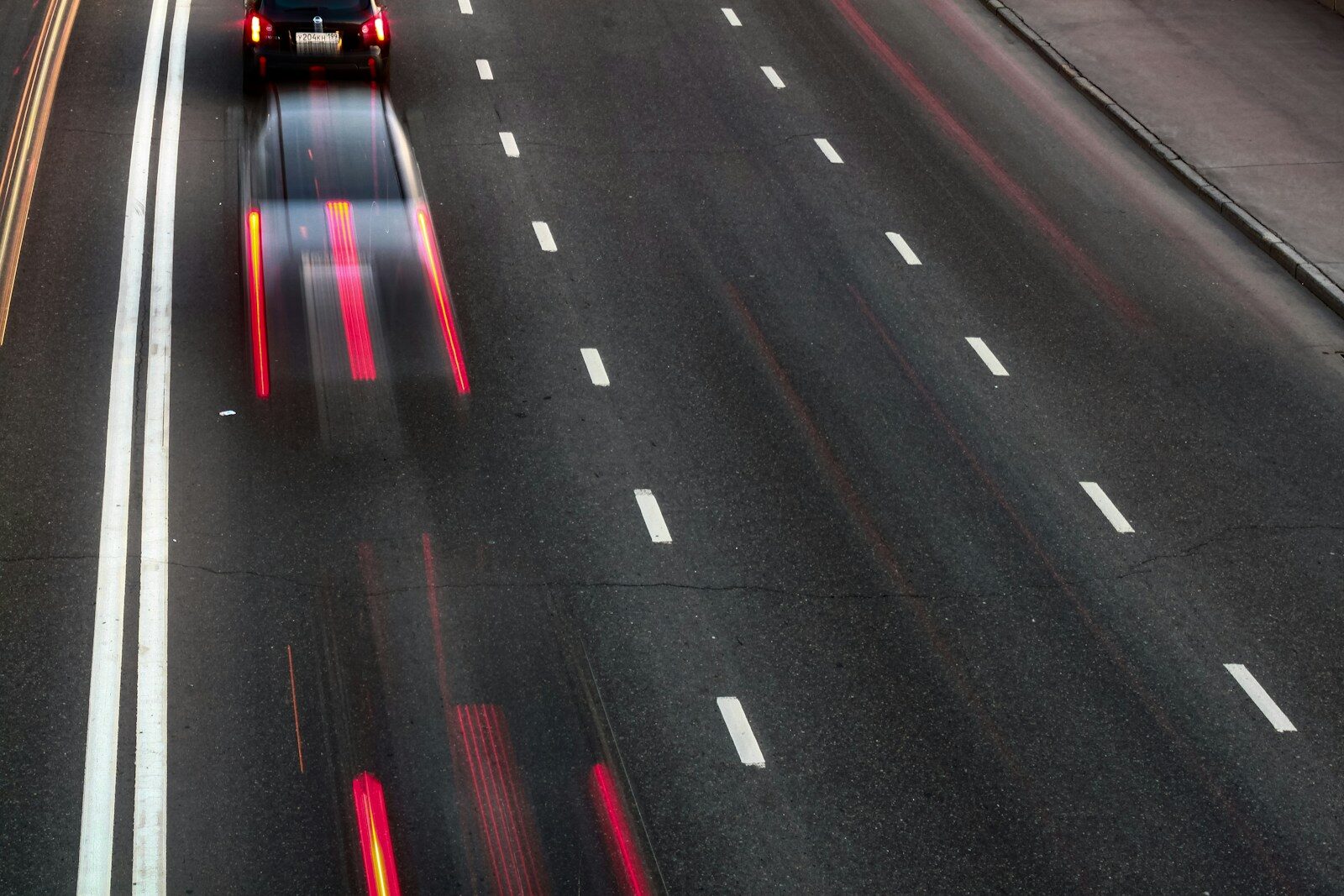 a car driving down a highway at night