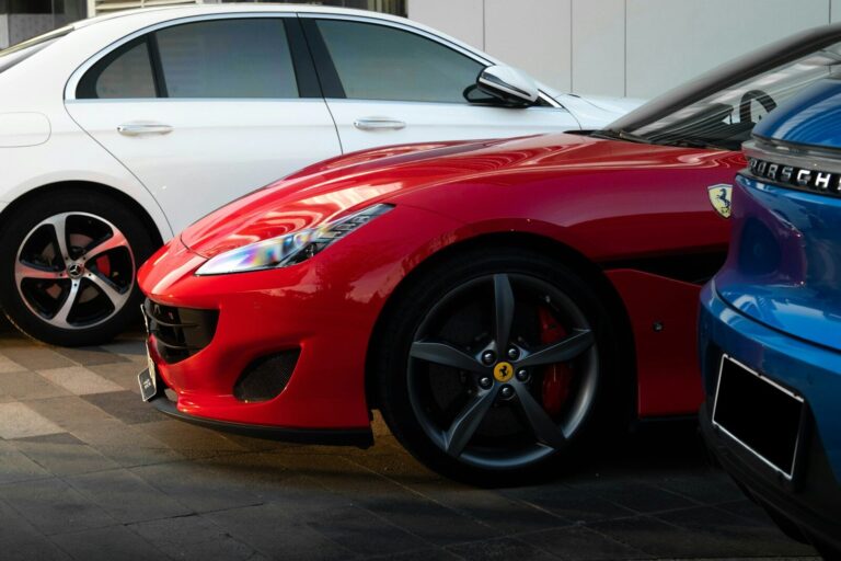 a red car parked next to a blue car