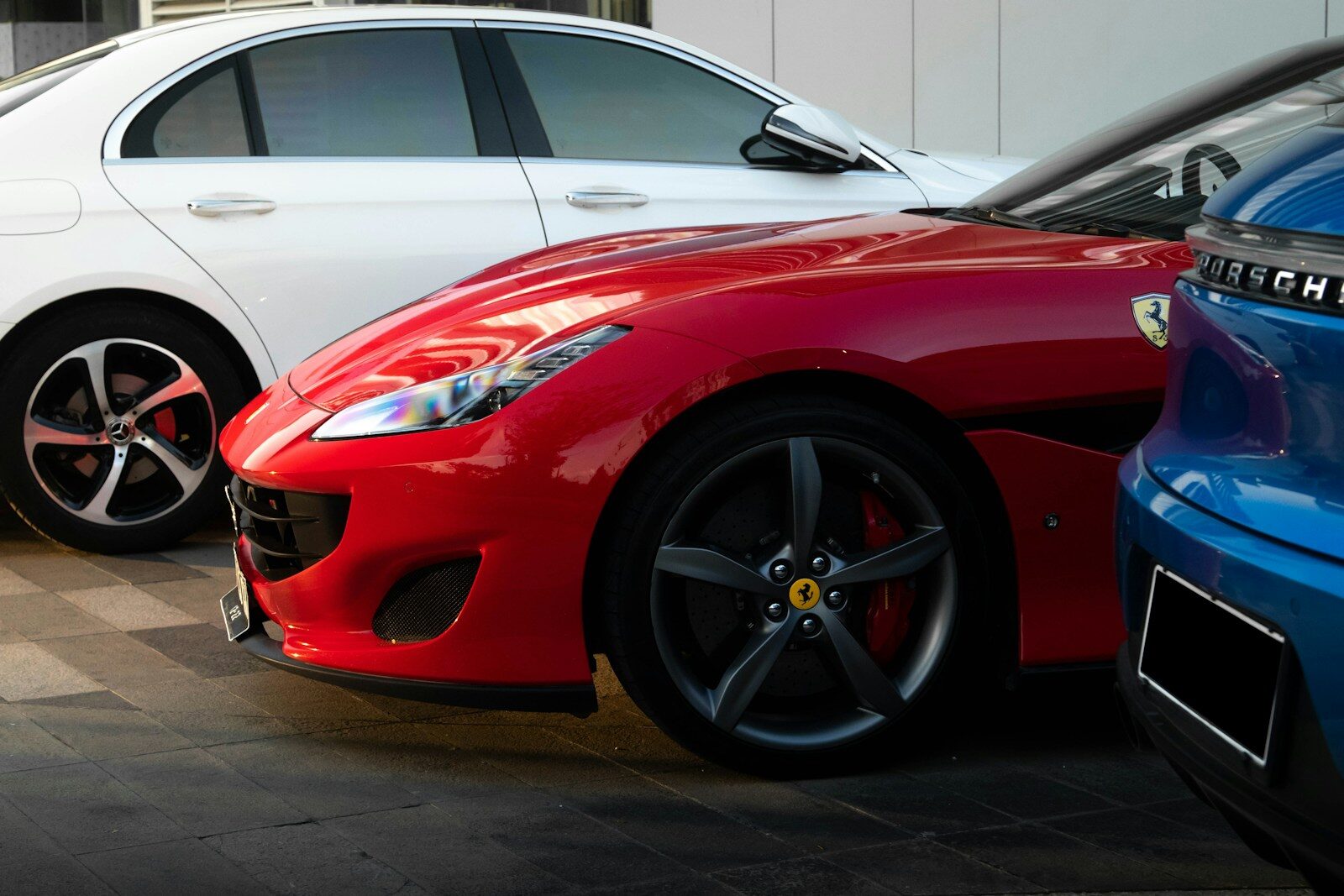 a red car parked next to a blue car