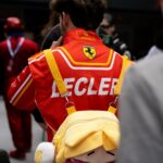 Red ferrari racing suit with 'lecler' on the back.