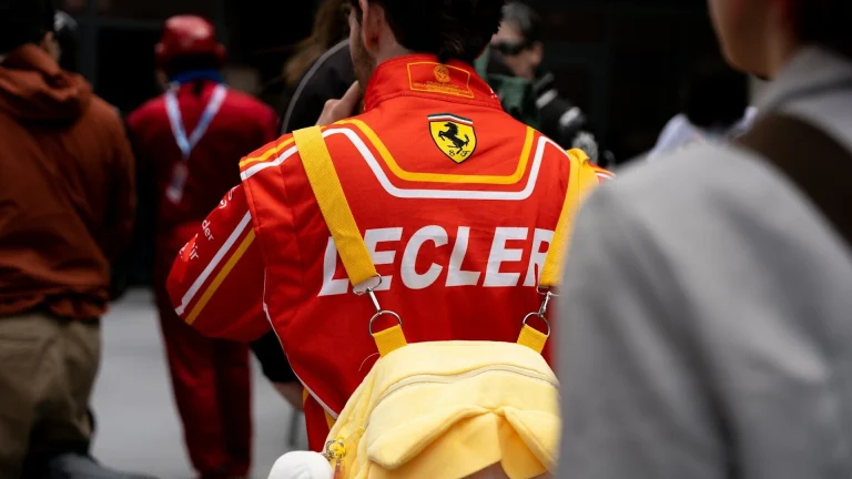 Red ferrari racing suit with 'lecler' on the back.
