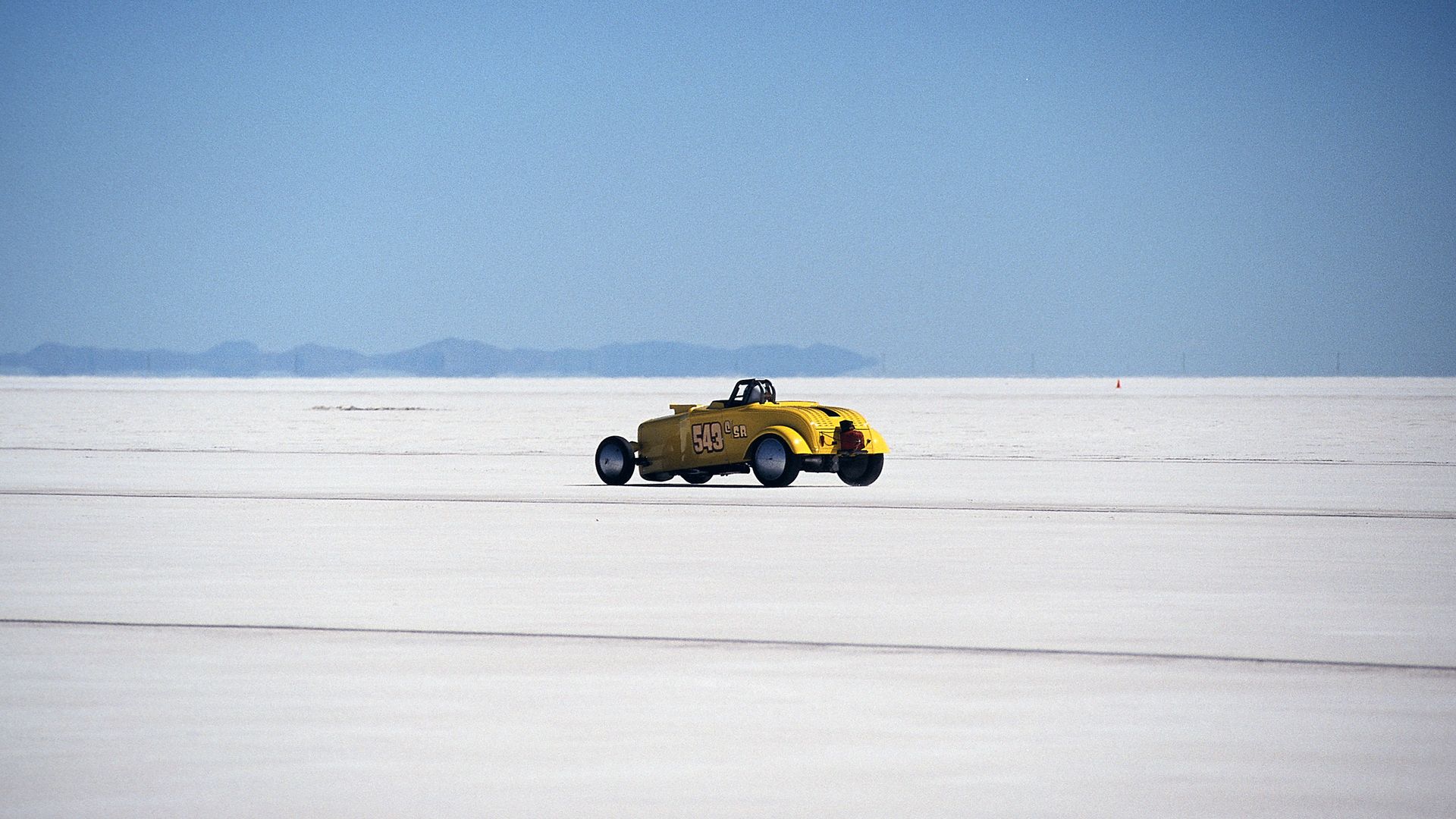 Yellow hot rod racing on Bonneville salt flats in Utah - Photo by mysurrogateband on Pexels