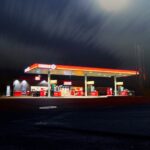 Circle gas station along the road during night time