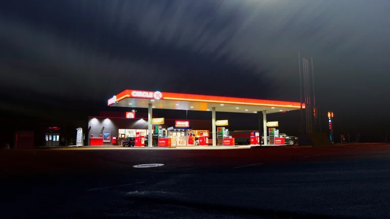 Circle gas station along the road during night time