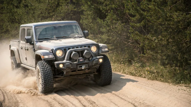 black and white jeep wrangler on dirt road during daytime
