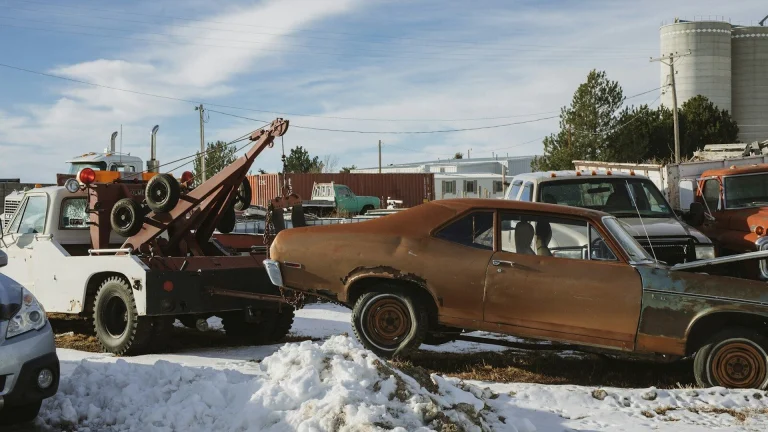 brown and white vintage car on snow covered ground during daytime