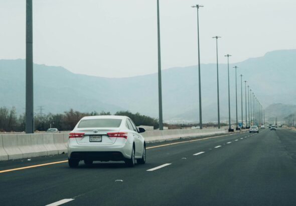 a white car driving on a road