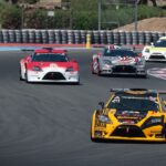 a group of cars driving down a race track