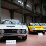 A row of old cars in a building