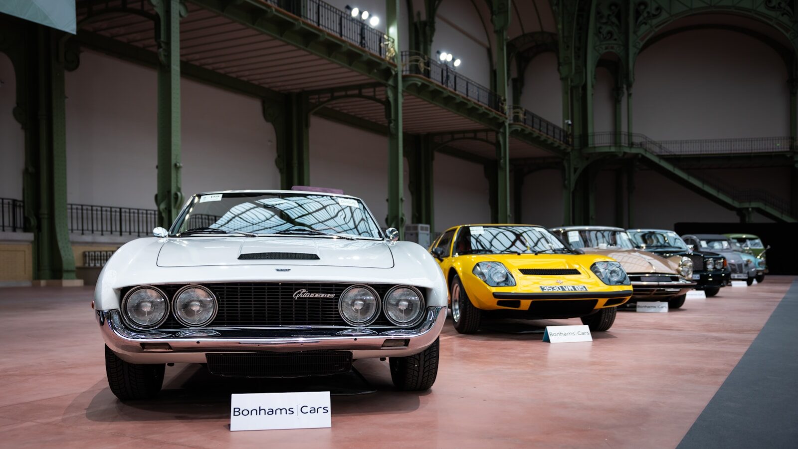 A row of old cars in a building