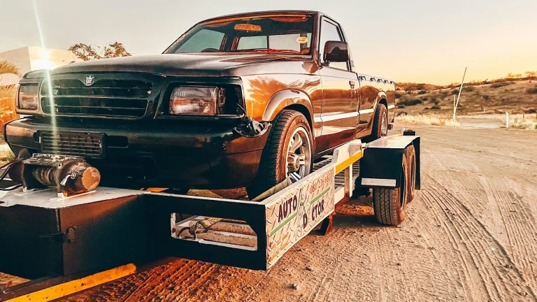 a truck is being towed on a flatbed trailer