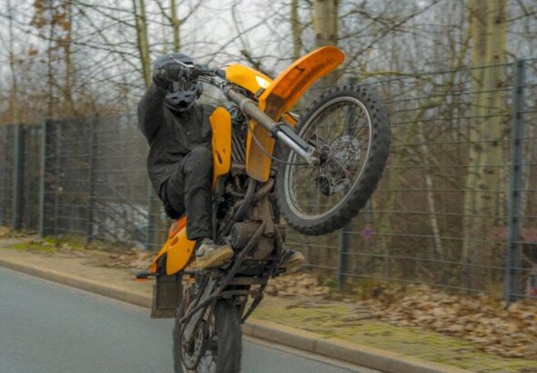a person on a motorcycle doing a trick in the air