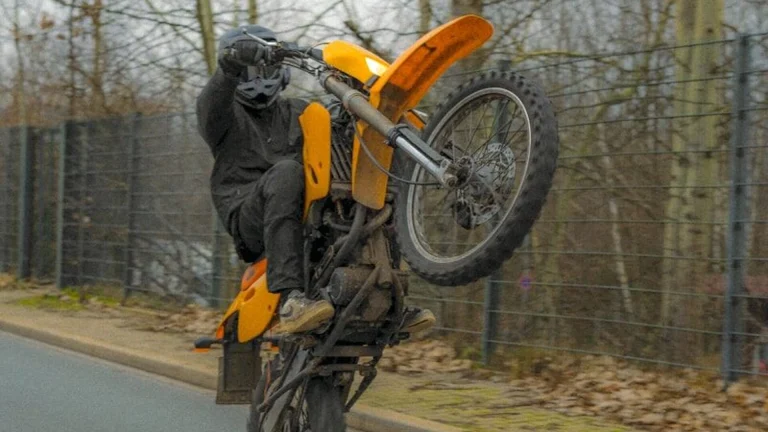 a person on a motorcycle doing a trick in the air