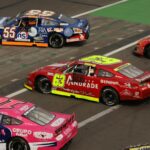 Stock cars racing side by side on a NASCAR short track