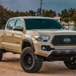 white Toyota crew cab pickup truck on ground