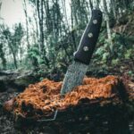 black handled knife on brown log
