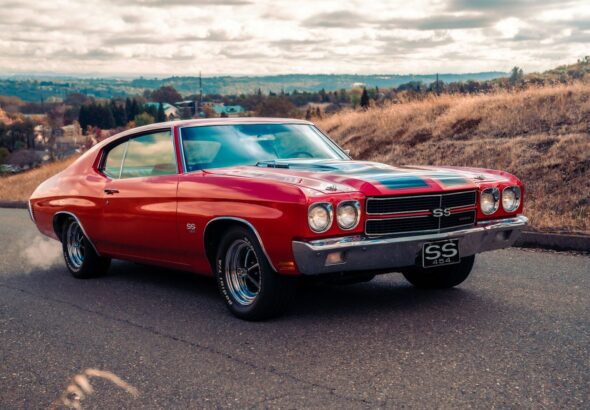 red chevrolet camaro on road during daytime