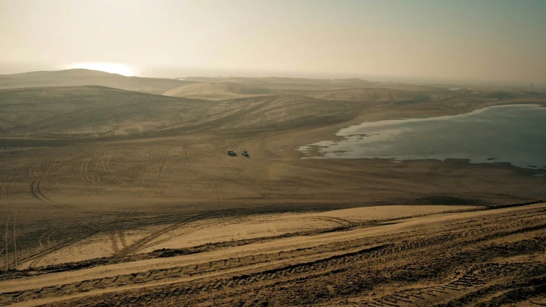 Vast desert landscape with a body of water