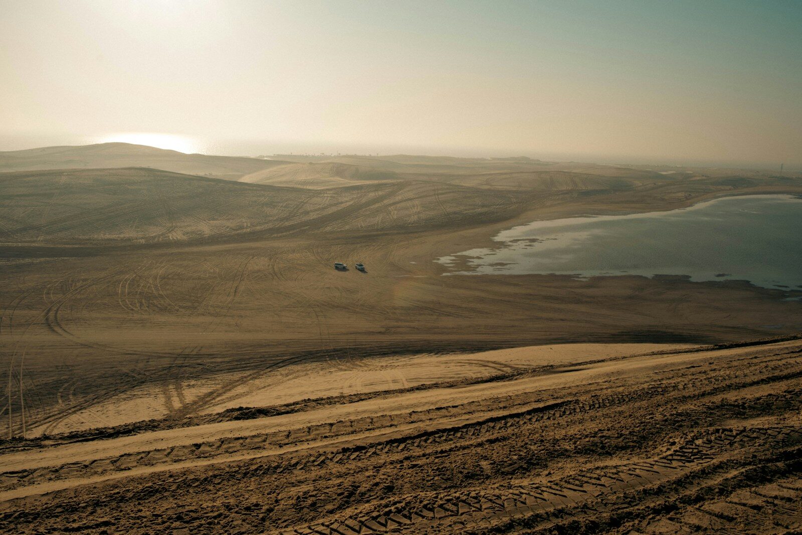 Vast desert landscape with a body of water