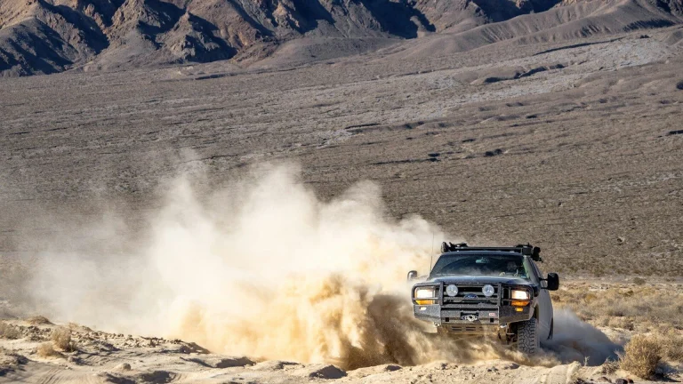 black suv on brown sand during daytime