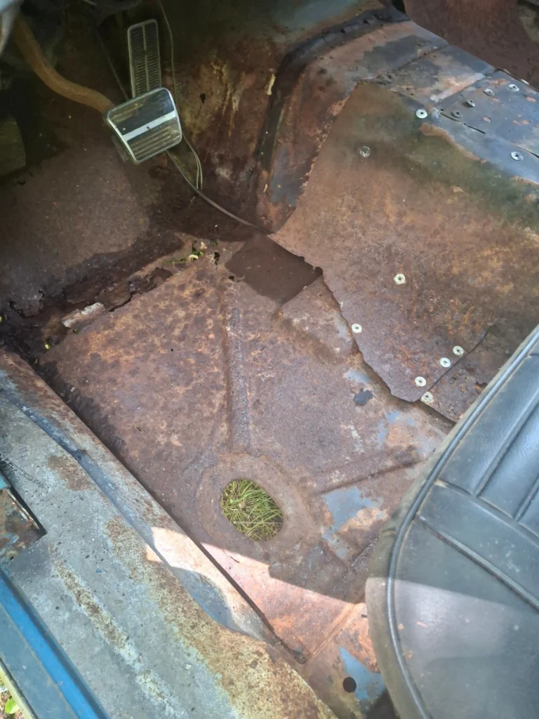 Rusted floor pan of the 1968 Chevrolet Camaro restomod project car, from eBay listing by seller tkk0522